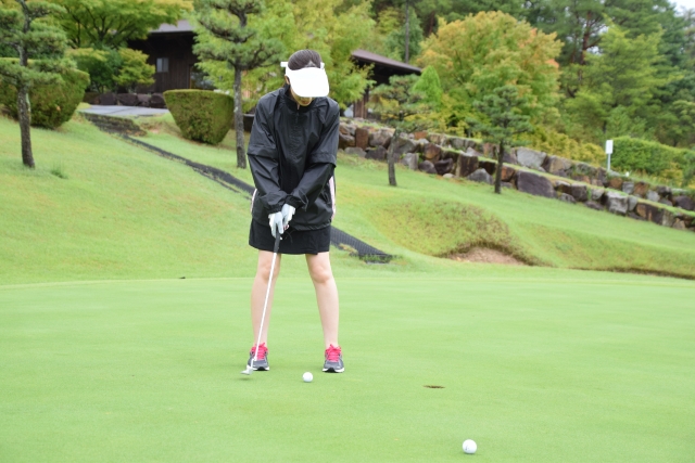 グリーンでパッドをする女性